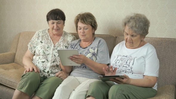 Elderly Women Holding Digital Tablets At Home