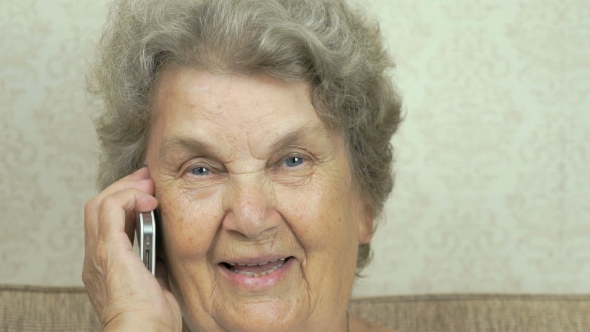 Grandmother Having a Call On Mobile Phone Indoors