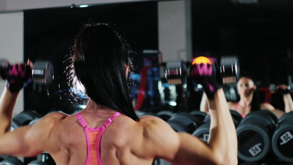 Athletic Woman Training With a Dumbbell alt