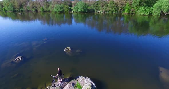 Cyclist Near River alt