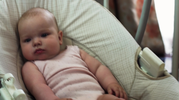 Mother Give Toy To Adorable Little Baby Sway On Swing In Apartment. Playing alt