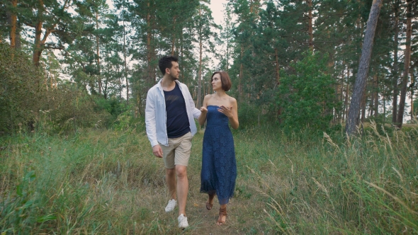 Young Couple Walking In The Woods Or The Park, Not Far From His Home. alt