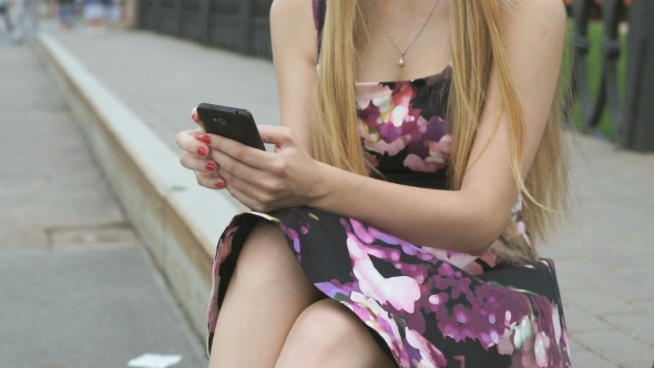 Young Girl With a Mobile Phone Outdoors