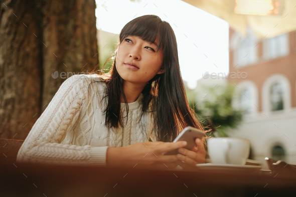 Beautiful young asian woman at outdoor cafe