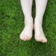 Movement And Rubbing Female Legs Against Each Other On a Background Of Green Grass - VideoHive Item for Sale