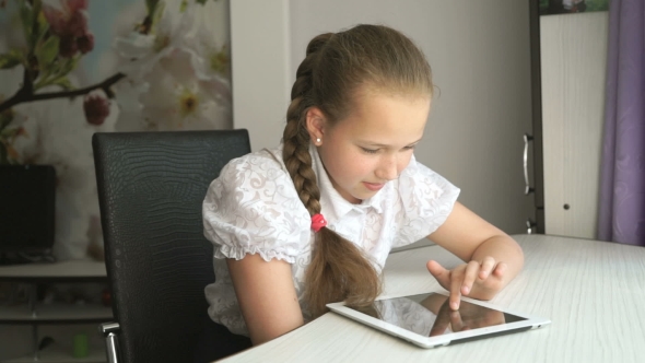 Primary Schoolgirl Using a Digital Tablet Computer alt