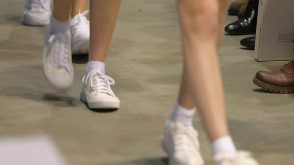 Marching Sporting Legs in White Sneakers