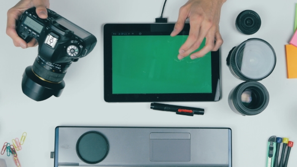 Workplace From Above. Unrecognizable Photographer Working With His Camera, Tablet, Memory Card. Top alt