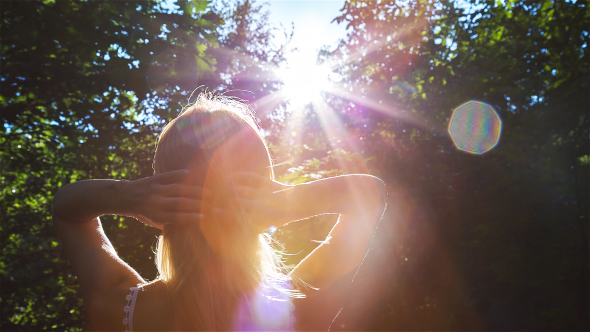 Beautiful Blonde Girl Playing with the Sun in City Park 2 alt