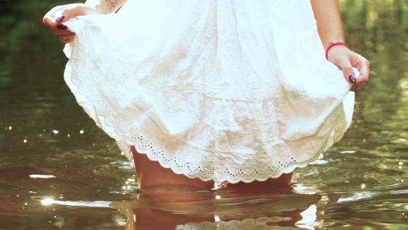 She Enters The River, Picking Up a Little Dress Exposing Beautiful Legs.