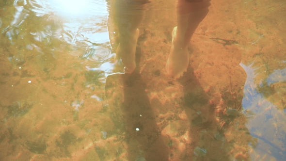 Feet Girl Under Water. Which Is On The River Bottom.