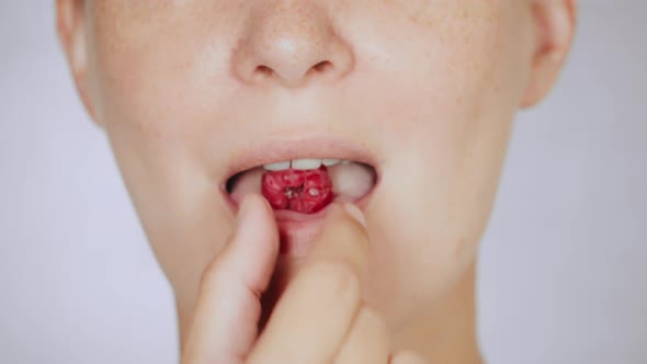 Close Up Face Young Woman Eating Razz alt