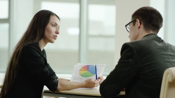 Colleagues Analyzing Diagram alt