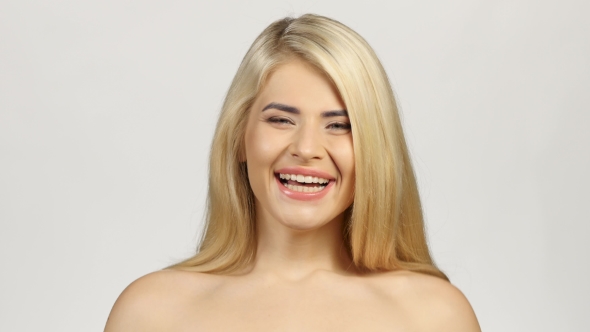 Blonde Woman Smiling Facing Forwards. White alt