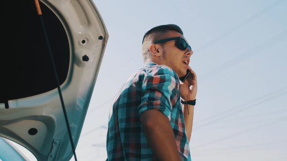 Boy In Sunglasses Stay At Broken Car At Road And Talk On Phone. Waiting For Help alt