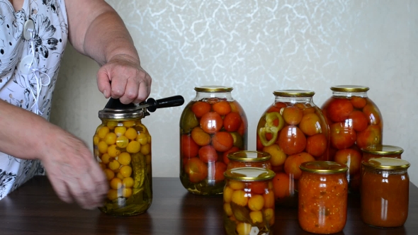 Mature Housewife Closes Banks Of Homemade Preserves