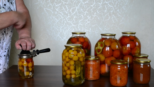 Mature Housewife Closes Banks Of Homemade Preserves