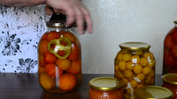 Mature Housewife Closes Banks Of Homemade Preserves