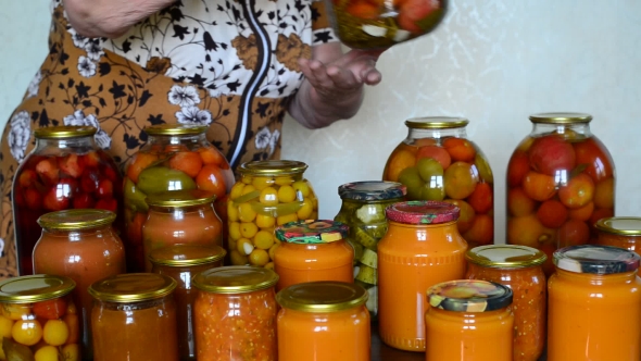 Mature Housewife Closes Banks Of Homemade Preserves