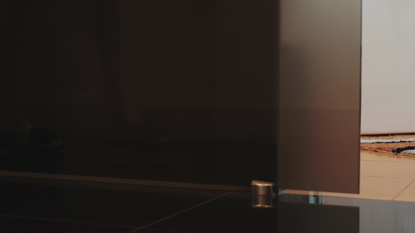 View Of Young Girl In Slippers Walk To Bathroom And Sit Down On White Bath. alt