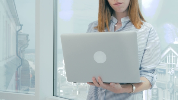Unrecognizable Businesswoman Hands Working On Laptop Computer At Modern Bright Office. alt