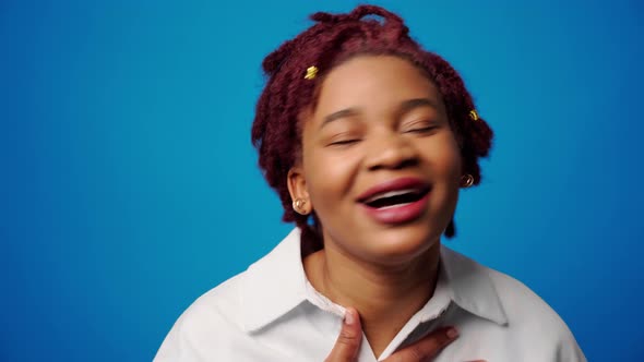 Happy Smiling Young Afro Woman Feeling so Grateful Putting Hand on Her Chest