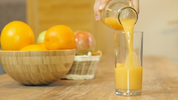 Orange Juice Pouring Into Glass alt
