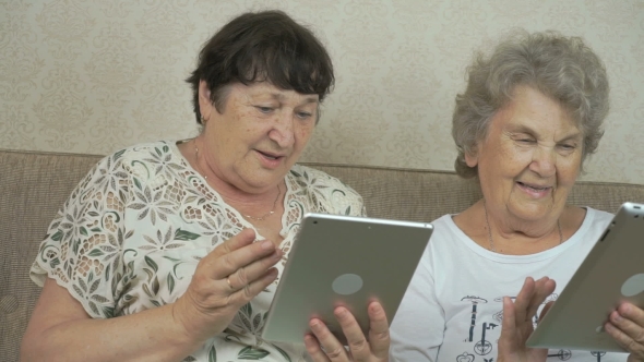 Old Women Holding The Silver Digital Tablets