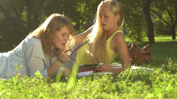 Two Girls Listening To Music In The Park