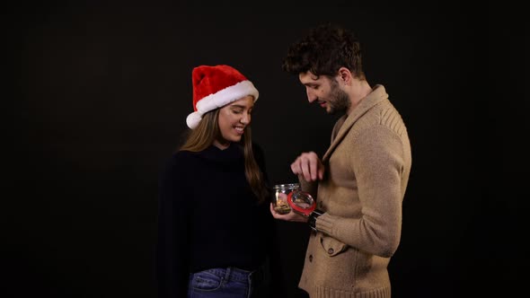 Young couple eating cookies alt