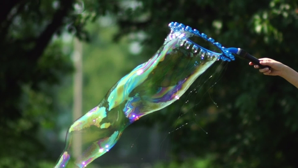 Giant Soap Bubble, And a Lot Of Small Around The Device For Creating