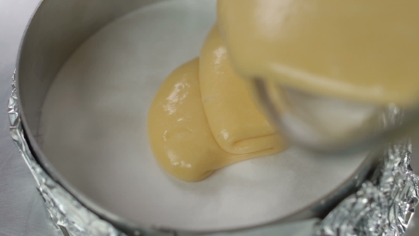 Pouring Fresh Pastry Cream In Metal Mould For Cake