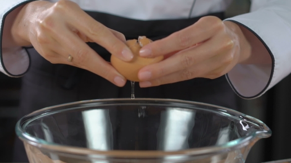 Woman Hands Break Egg Into Glass Bowl
