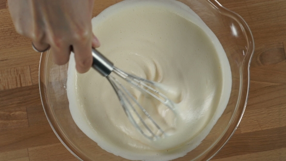 Woman Hand Mixing Cream And Egg For Cooking Dessert