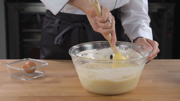 Woman Chef Cooking Buttery Cream On Kitchen