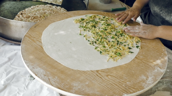 Woman's Hands Putting Filling And Oil On The Dough