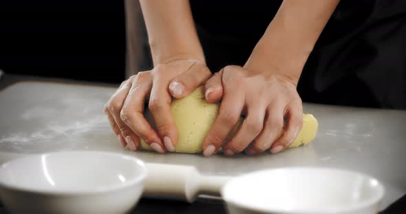 Women's Hands Knead the Dough for Shortbread Cookies on a Silicone Mat