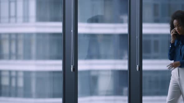 Young African Businesswoman Talking Phone Speaking Manager Boss in Office Centre alt