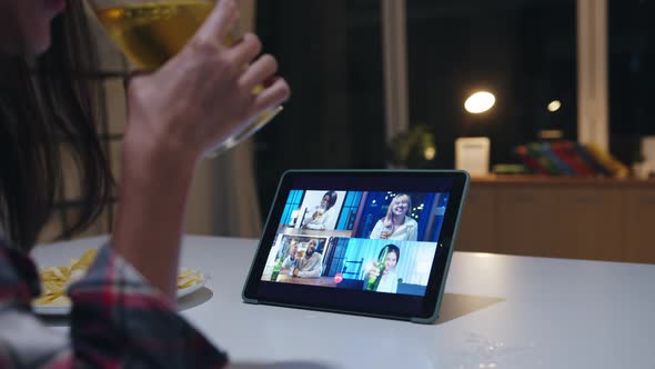 Young Asian lady drinking beer having fun happy night party event online via video call at home. alt