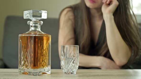 Woman in Tears is Drinking Whiskey Alone