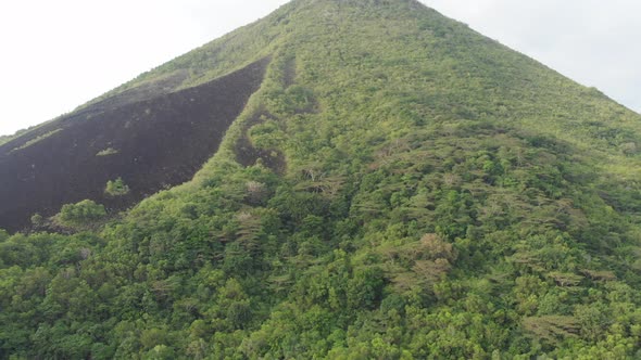 Aerial: flying over Banda Islands active volcano Gunung Api lava flow Indonesia  alt