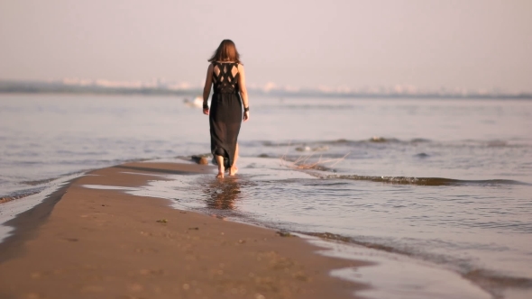 Young Woman Walking On a Coast Line Water Line Legs