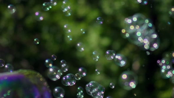 A Lot Of Small And Big Multi-colored Bubble Blower. Soap Bubbles Show. alt