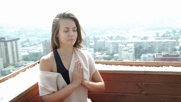 Beautiful Woman Doing a Yoga Exercise On He Rooftop Of a Skyscraper. 20S.