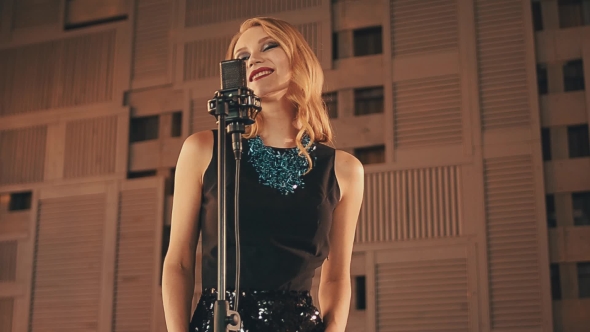 Jazz Vocalist In Glowing Dress Perform On Stage. Elegant. Dancing. Male Up. alt