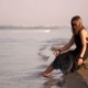 Girl In a Black Dress Sitting On a Rock By The River Feet In The Water - VideoHive Item for Sale