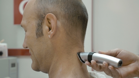 Barber Is Shaving His Client's Neck With Shearer
