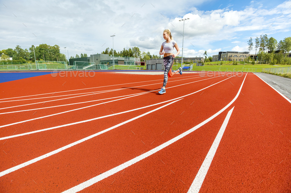 Young Woman Running On Sports Tracks