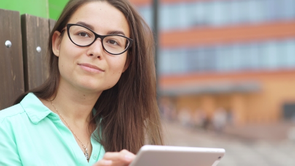 Beautiful Student In Glasses With a Digital Mini Tablet