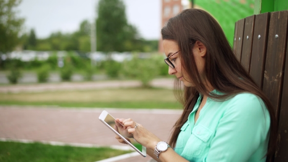 Elegant Young Girl Using The Mini-Tablet alt